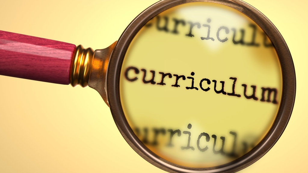 The word curriculum with a magnify class directly over it to demonstrate accessible curriculum.